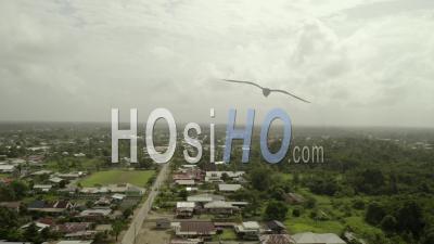 Remote Village Town In Suriname, On Overcast Day, Aerial Rising View - Video Drone Footage