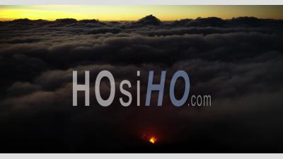 Over The Clouds With Volcano Eruption - Video Drone Footage