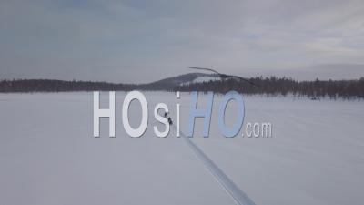 People Driving On Snowmobiles In A Snowy Plain, Tackasen, Sweden - Video Drone Footage