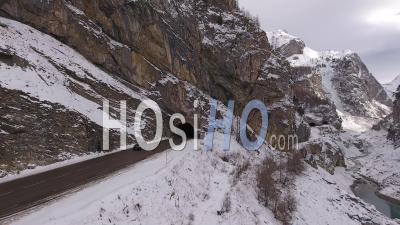 Two Cars Getting Out Of A Tunnel In The Alps Mountains, Tignes, France - Video Drone Footage