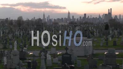 Rising Aerial Of Vast Cemetery In New York City Suggests Victims From Coronavirus Covid-19 Pandemic Epidemic Outbreak Deaths. - Video Drone Footage