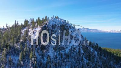 2020- Beautiful Revealing Aerial Of Lake Tahoe From Behind A Snowy Mountain Peak. - Video Drone Footage