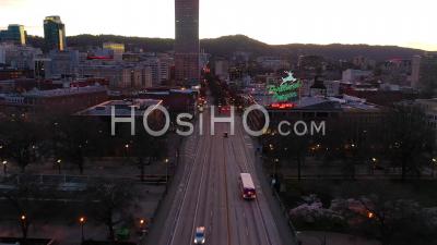Moody Aerial Past Portland Oregon Stag Deer Sign And Downtown Old Town Cityscape And Business District At Sunset Or Dusk. - Video Drone Footage