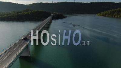 Aerial View Of Car Crossing The Bridge Over The Lake Of Saint Cassien, Drone Point Of View
