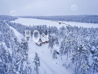 Aerial Drone Photo Of Cabins And Huts In Forest, With Snow Covered Winter Landscape, Arctic Circle, Finnish Lapland, Finland