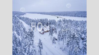 Aerial Drone Photo Of Cabins And Huts In Forest, With Snow Covered Winter Landscape, Arctic Circle, Finnish Lapland, Finland