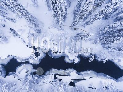 Aerial Of Frozen River And Snow Covered Forest Winter Landscape Showing Amazing Lapland Scenery In Scandinavia In Finland - Aerial Photography