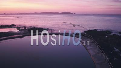 Guernsey Tidal Bathing Pools With Herm Island Behind At Sunrise, Channel Islands, Uk. Aerial Drone View