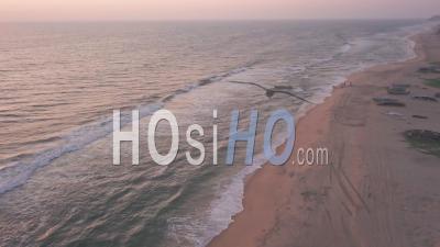 The Stunning Scenery Of The Waves Crashing On The Shore In Varkala, India During Golden Hours - Aerial Drone Shot
