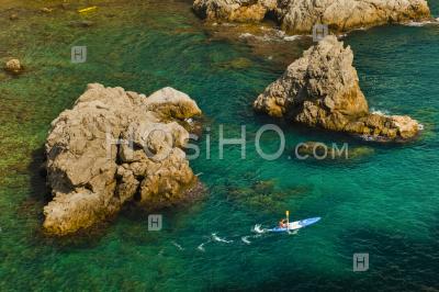 Sea Kayaking In Dubrovnik, A Tourist Kayaking In The Mediterranean Sea, Croatia