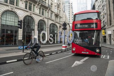 Quiet Roads And Streets In The City In Central London With Just A Red London Bus For Public Transport, And A Cyclist On A Bicycle Taken During Coronavirus Covid-19 Lockdown In England, Uk, Europe