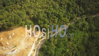 Construction Work Beside The Green Forest At Asia Country - Video Drone Footage