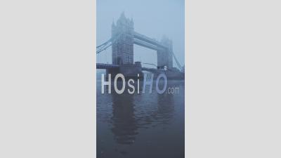 Vertical Video Of Tower Bridge And River Thames In Foggy And Misty Weather Conditions In London City Centre On Blue Atmospheric Morning With Mist And Fog In Coronavirus Covid-19 Lockdown, England, Uk