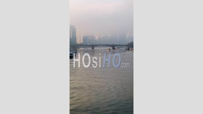 Vertical Video Of Iconic Central London City Skyline And River Thames With Red London Bus Driving Over Lambeth Bridge In Misty Foggy Sunset Sky, Shot In Coronavirus Covid-19 Lockdown In England, Uk
