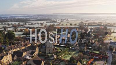 Aerial Drone Video Of A Cotswolds Village, English Countryside Fields And Scenery With Houses, Property And Real Estate In The United Kingdom Housing Market, Bourton On The Hill, Gloucestershire, England