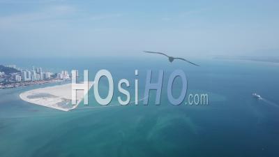 Aerial View A Cruise Ship Is Move At Penang Sea Near Reclamation Island - Video Drone Footage