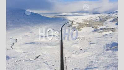 Aerial View Of A82 Road Crossing Rannoch Moor Covered In Snow During Winter, Highlands,Scotland, Uk - Aerial Photography