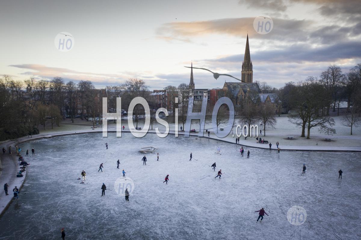 Ice Hockey On Frozen Pond At Queens Park In Glasgow, Scotland, Uk - Aerial Photography