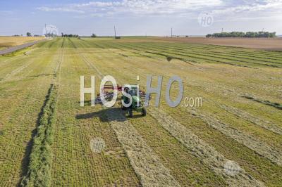 Farmer Pulls Hay Rake In Colorado Field - Aerial Photography
