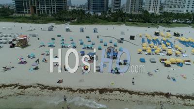 Umbrellas And Colors For A Sunny Sunday On The Beach - Video Drone Footage