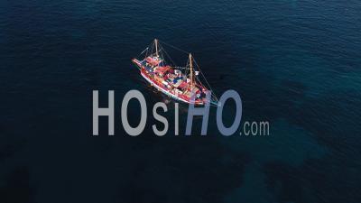 Aerial View Of A Tourist Cruise Ship Sailing Near The Rocky Mediterranean Coast Of The Greek Island - Video Drone Footage