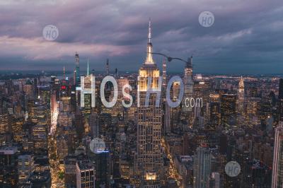 Breathtaking View Of The Empire State Building At Night In Manhattan, New York City Surrounded By Skyscrapers At Night Hq - Aerial Photography