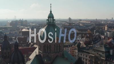 Close Up Aerial View Of Cathedral Church Top With Christian Cross And Clock On Tower, Beautiful Old Architecture In Munich, Germany, Drone Slide Circle Around Building
