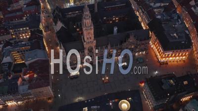 Tilt Down Revealing Famous Marienplatz In Munich, Germany At Night From Aerial Perspective - Video Drone Footage