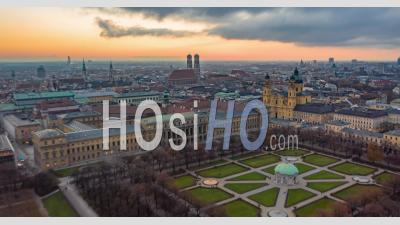 Munich, Germany Cityscape With View Of Frauenkirche Cathedral And Beautiful Old City Architecture With Sun Setting, Aerial Hyper Lapse, Moving Time Lapse Above Big German City - Video Drone Footage