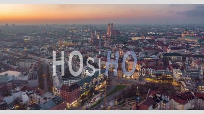 Beautiful Munich, Germany Establishing Shot Hyper Lapse Above City Center With Frauenkirche Cathedral And Marienplatz, Day To Night Time Lapse With Sunset And Big City Traffic - Video Drone Footage