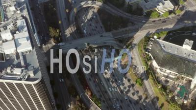Birds Eye View Of Downtown Los Angeles, California Intersection Traffic With Palm Trees And Skyline Blue Sky And Sunny Day 4k - Video Drone Footage