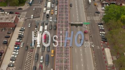 Aerial Tilting Dolly Shot Following Scarce Traffic Across The Bridge Out Of Manhattan With Dense Traffic Jam On The Way In 4k - Video Drone Footage