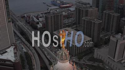 Aerial Close Up View Of Golden Civic Fame Statue On Top Of The Manhattan Municipal Building With Busy Car Traffic Towards Brooklyn Bridge Below 4k - Video Drone Footage