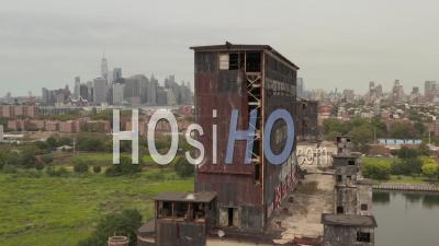 Close Up Aerial Dolly View Of Empty Old Red Hook Grain Terminal With New York City Cityscape In The Background 4k - Video Drone Footage