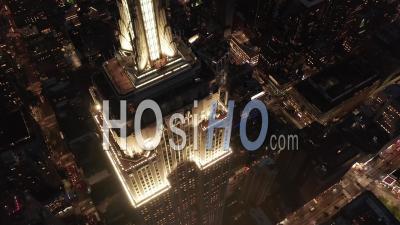 Breathtaking Flight Over The Iconic Empire State Building Above Lit Up Parallel Avenues And Junctions Residential Condominiums And Office Buildings In Midtown Manhattan, New York City Night 4k - Video Drone Footage