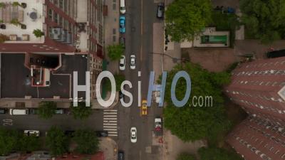 Top Down Overhead Aerial Shot Following A Yellow New York City Taxi Driving Through Residential Neighborhoods In The City 4k - Video Drone Footage