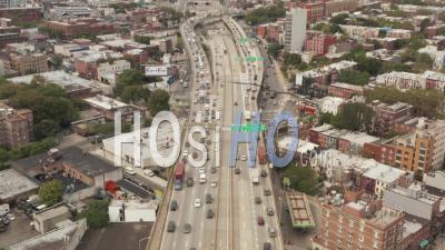 Aerial View Flying Backwards Following Multi Lane City Traffic Across The Bridge In Industrial Port Area Of New York City 4k - Video Drone Footage