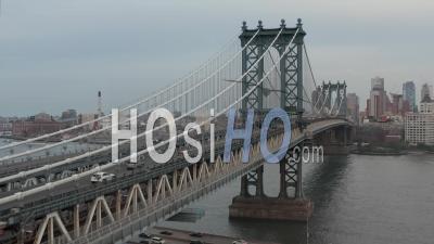 Aerial Dolly Rising Shot Flying Along And Above Manhattan Bridge With Multiple Vehicles Crossing The Bridge Across East River Towards Brooklyn 4k - Video Drone Footage