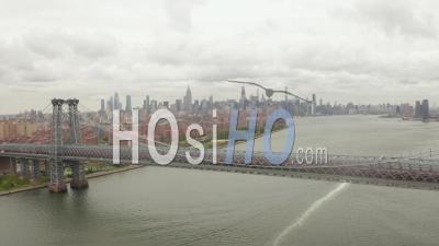 Wide Aerial Dolly View Of Williamsburg Bridge Across East River With East Village And New York City Skyscraper Skyline In The Background 4k - Video Drone Footage