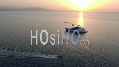 Fast Zodiac Boat In Front Of Luxury Yacht In The Sunrise On The Bay Of Antibes, French Riviera, Filmed By Drone, France