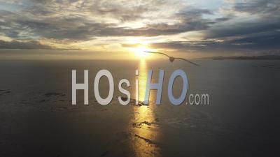 Aerial Fly Backward During Dramatic Sunset Hour - Video Drone Footage