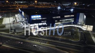 Aerial Rotation Ikea And Car Traffic At Night - Video Drone Footage