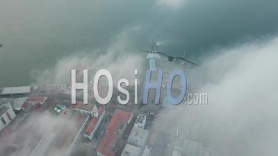 Aerial View Ferry Terminal Over The Fog Cloud - Video Drone Footage