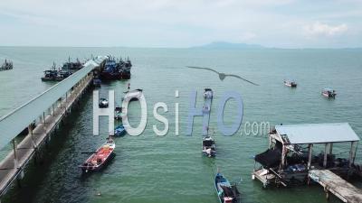 Aerial View Teluk Bahang Fishing Village, Fisherman Boats Park In A Row - Video Drone Footage