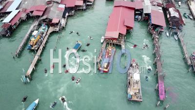 Aerial View Jet Ski And Goddess Of Sea Mazu Boat Arrive The Jetty. - Video Drone Footage