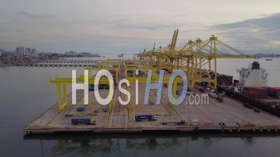 Aerial Tracking Container Terminal Reveal The Ship Carry Containers. - Video Drone Footage
