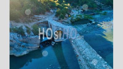 Vertical View Of Stone Bridge At Thermal Bath And Pools Of Springs Of Benje Over River Lengarica, Albania - Aerial Photography