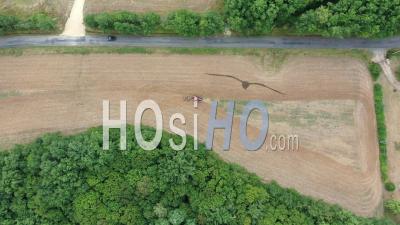 Tractor Plowing A Field In Summer In Saint-Georges-Blancaneix In Dordogne - Video Drone Footage