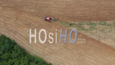 Tractor Plowing A Field In Summer In Saint-Georges-Blancaneix In Dordogne - Video Drone Footage