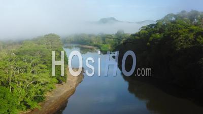 Aerial Drone View Of San Carlos River (rio San Carlos) In Costa Rica, That Connects To Nicaragua, With Lush Green Misty Rainforest Scenery And Misty Mountains, Central America